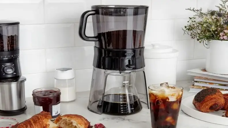 OXO cold brew maker on a counter with iced coffee and pastries