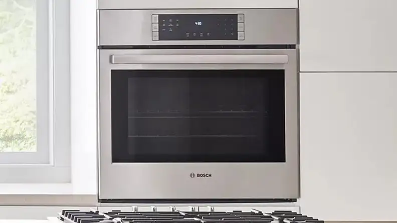Modern stainless steel oven in kitchen setting.