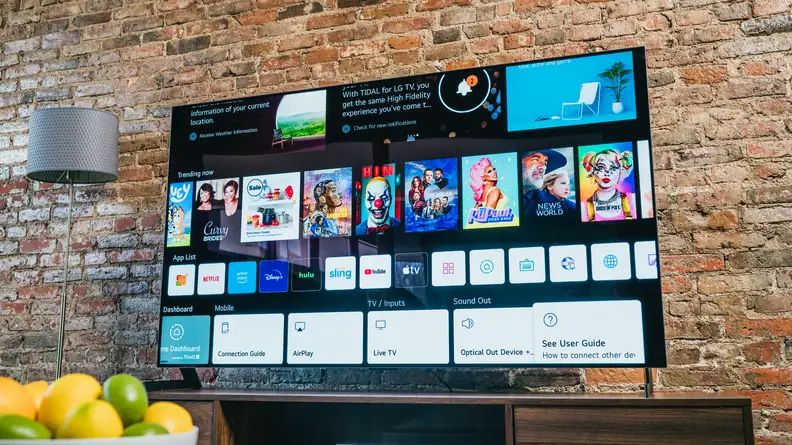 The LG G1 displaying the webOS home screen in a living room setting