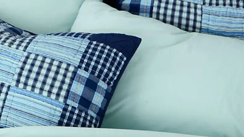 land's end flannel sheets on a bed with a navy patchwork quilt