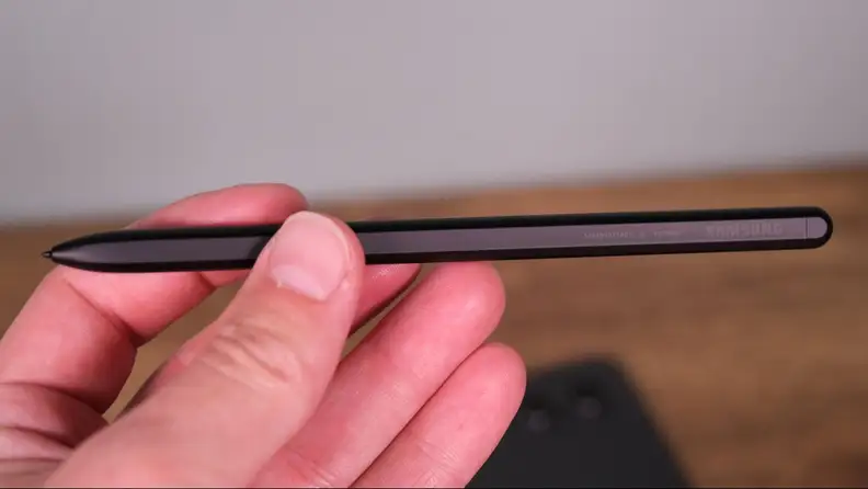 Our Reviewer holds a Samsung S Pen stylus, black in color