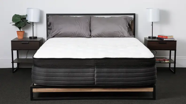 The Nolah Evolution mattress in a bedroom with bedside tables on either side.
