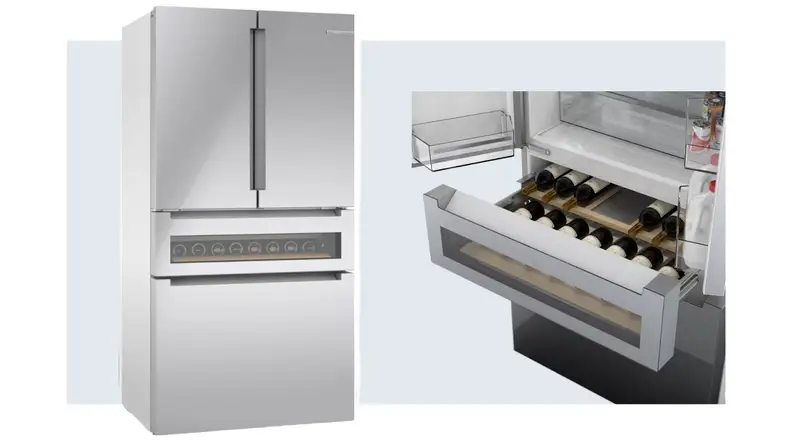 On left, stainless steel LG LRMVS3006S double-door refrigerator. On right, several bottles of red wine stacked inside of the Bosch Refreshment Center within the Bosch B36CL81ENG refrigerator.