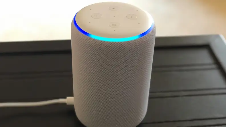 A third gen Amazon Echo speaker sits on a table