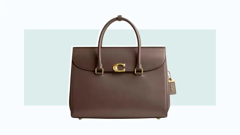 A brown handbag with a flap closure and top handles.