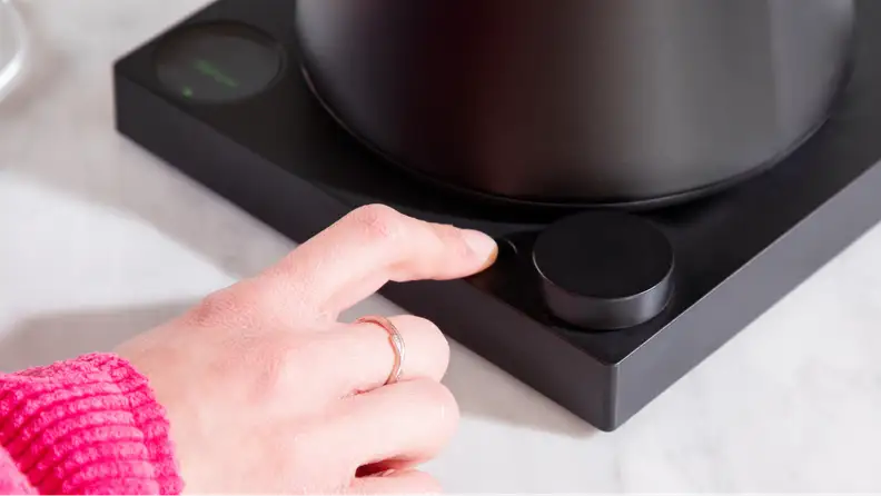 A hand pressing some unmarked buttons.