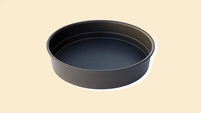 A round pan on a beige background.