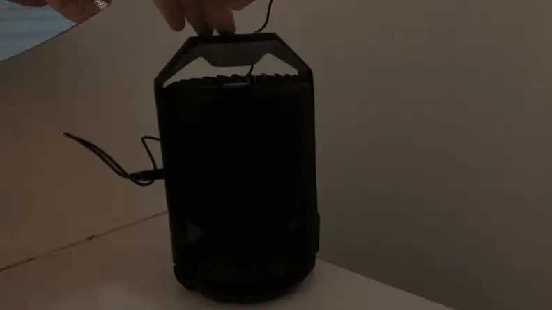 Person activating blue light on the Katchy Indoor Insect Trap.