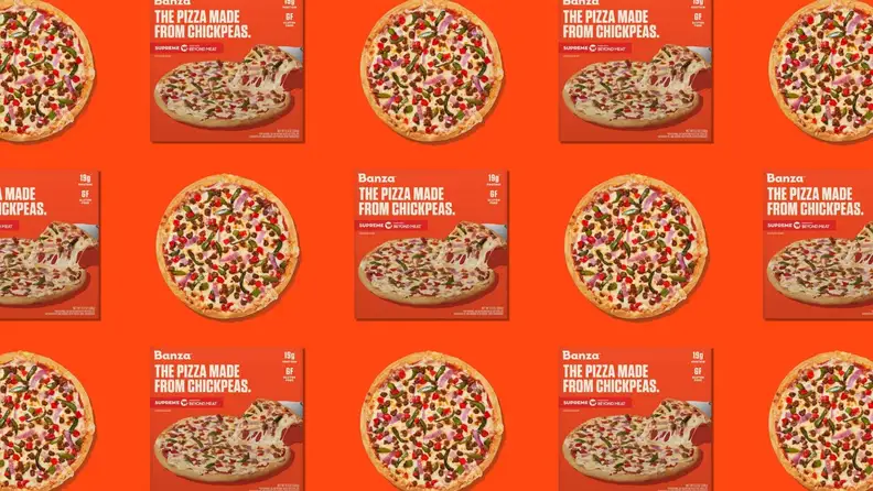 A pattern of frozen pizza boxes and frozen pizzas on an orange background.