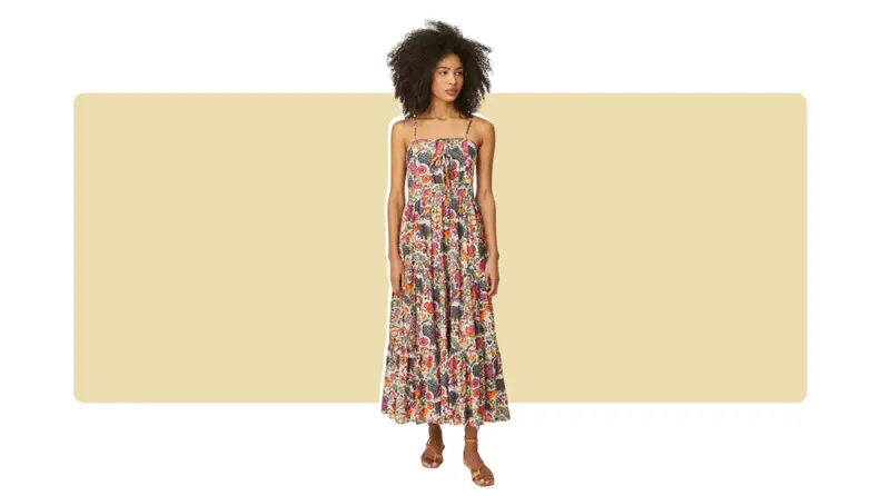 A midi-length casual dress with a floral print all over. There are simple lace bow-ties in front.