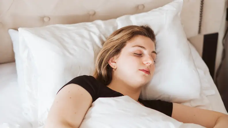 A woman sleeping in her bed.