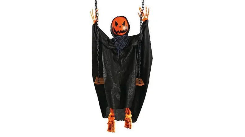 An image of a pumpkin-headed ghoul in dark robes sitting on a swing.