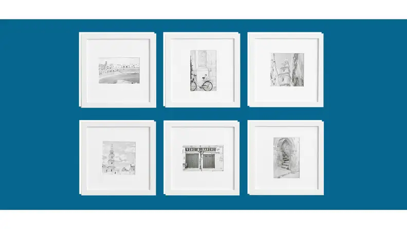 A wall filled with art frames.