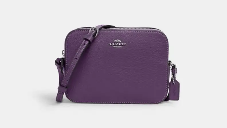 A purple Coach bag against a white background.