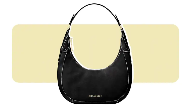 A crescent-shaped suede handbag.