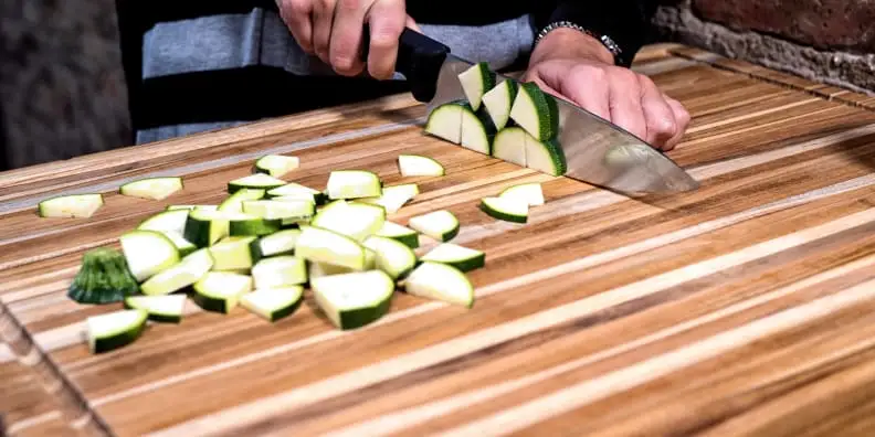 A sturdy wooden cutting board like the Teakhaus Carving Board provides a solid foundation for turkey carving.