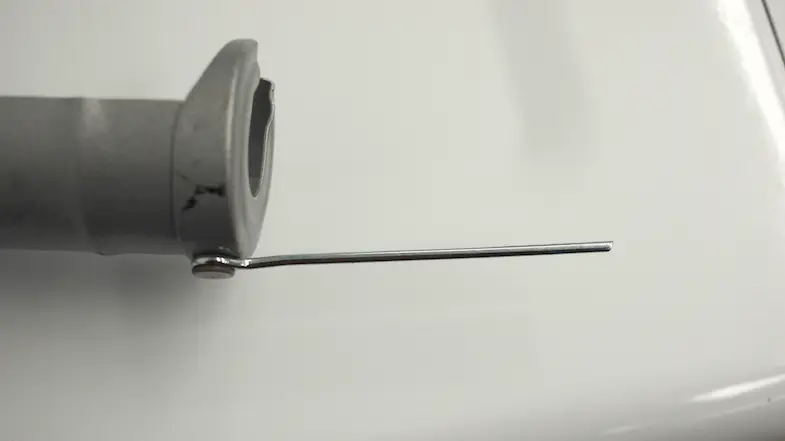 The tine on the caulk gun that punctures caulk tubes.