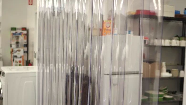 A plastic strip curtain hangs in the lab.
