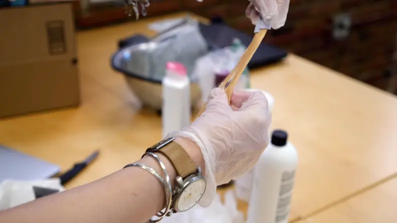 For each shampoo, we dyed six swatches of blond hair: three were dyed purple and three were dyed dark brown.