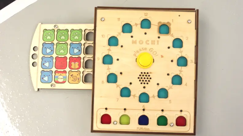 On the Mochi board, kids place coding pieces in the numbered slots in order to tell Mochi how to move across the playmat.