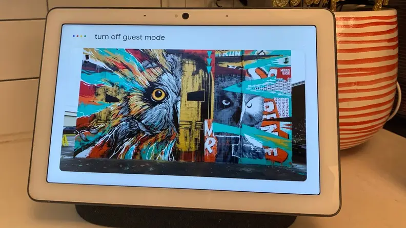 A work of street art is displayed on an iPad. At the top of the display, the a prompt reads, "Turn off guest mode."