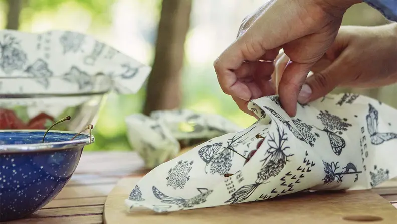 Wrapping food in beeswax wrap.