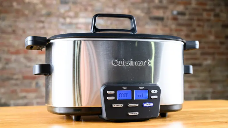 stainless steel crock pot on wooden table