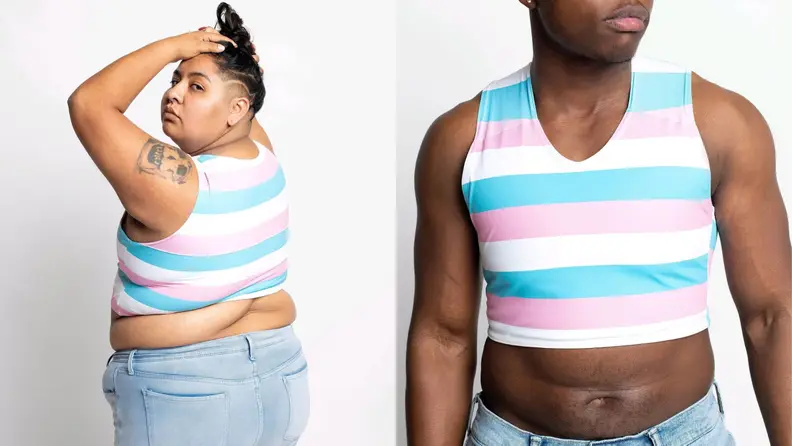A plus-size person looking over their shoulder wearing a trans-flag-colored binder and denim pants, next to a muscular person wearing a trans-flag-colored binder.