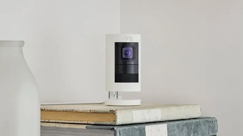 Security camera on stack of books.