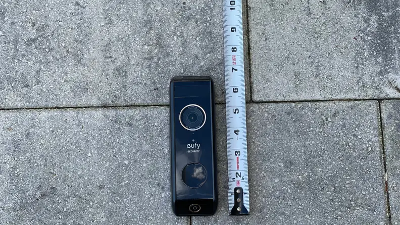 A video doorbell appears next to a tape measure.