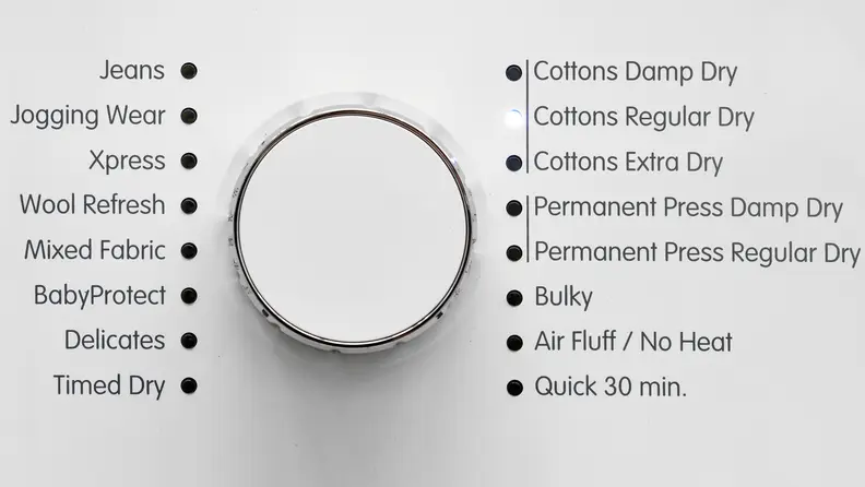 A close-up of a dryer's cycle selection dial with 16 different cycle settings: jeans, jogging wear, xpress, wool refresh, mixed fabric, BabyProtect, delicates, timed dry, cottons damp dry, cottons regular dry, cottons extra dry, permanent dress damp dry, permanent press regular dry, bulky, air fluff / no heat, quick 30 min.