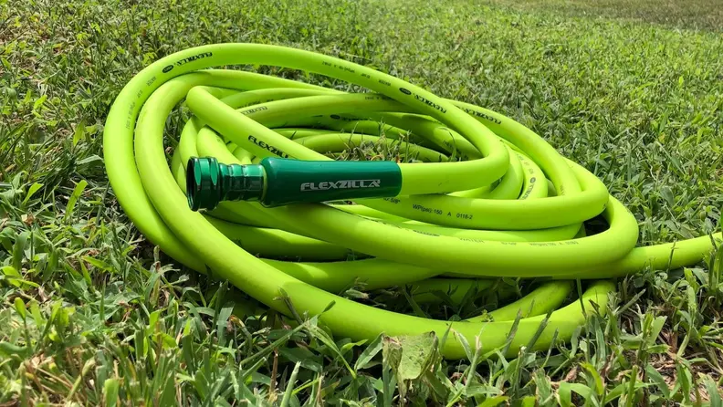 The Flexzilla garden hose sits on the grass