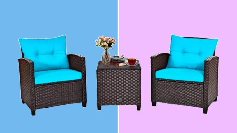 An image of two wicker black chairs with a small side table between them. The chairs both have teal blue cushions.