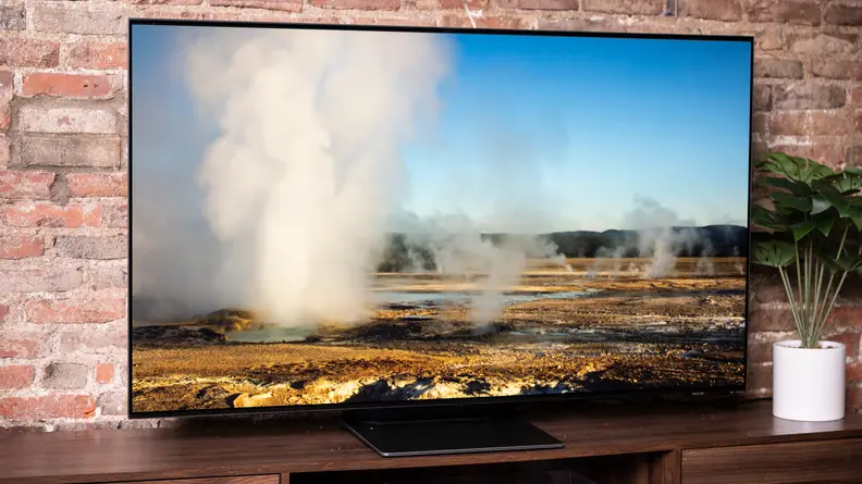 Smart television in front of brick wall.