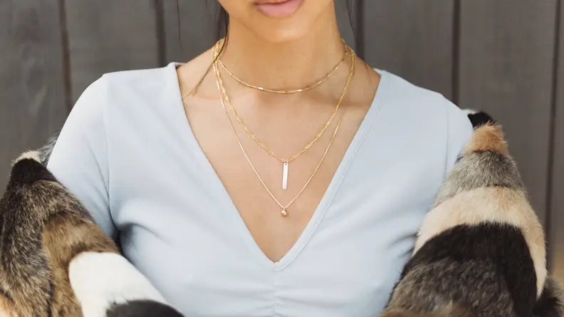 Black woman wearing gold necklaces
