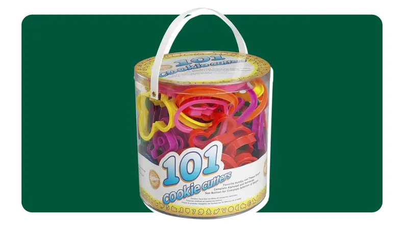 On left, bucket of cookie cutters on green background. On right, cookie cutters shaping dough on a countertop