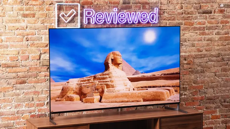 The Sony A95L QD-OLED TV displaying a high-resolution image of a boat moving along a bright, turquoise-colored river.