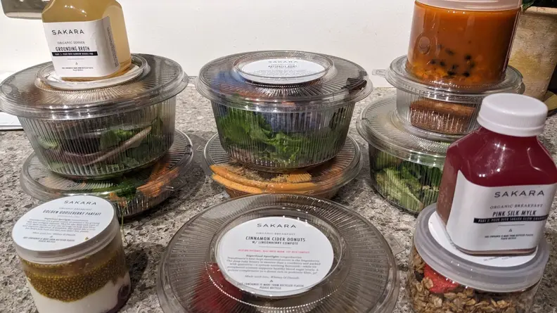 Sakara prepared meals and snacks laid out on a countertop