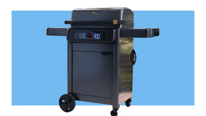The Current Backyard grill in front of a blue background.