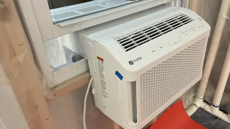 The GE Clearview AHTT06BC Window Air Conditioner in a mock window inside of a laboratory environment.