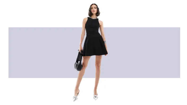 A black mini dress with embellishments along the neckline.