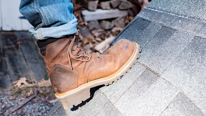 Our winner for the best work boot, the Chippewa 55025 Hador Steel Toe Boots, being worn on a shingled rooftop.