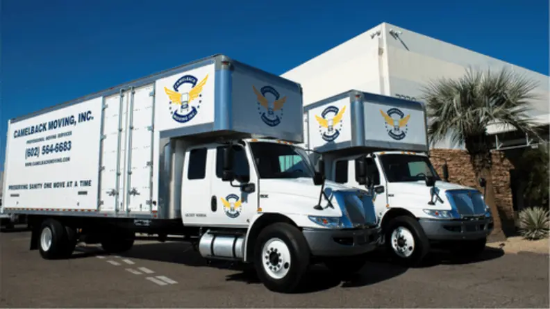 Two large white moving trucks