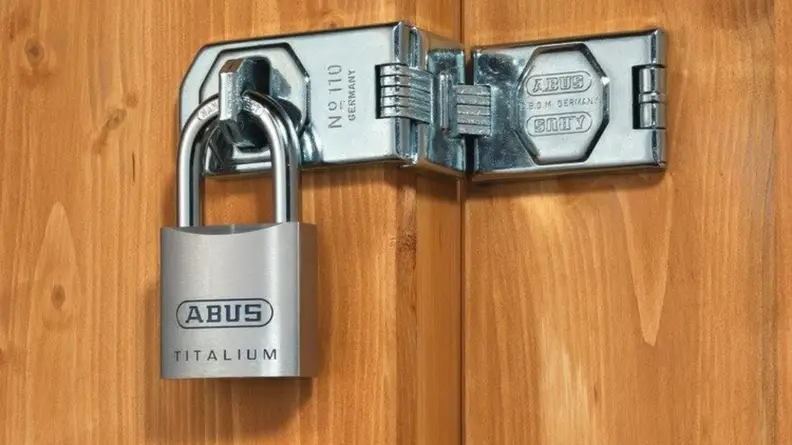 Abus Titalium Alloy Padlock being used to hold a wooden door shut