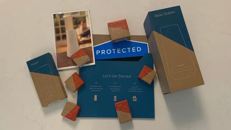 The SimpliSafe 8-piece Wireless Home Security System packaging on a white quartz countertop.