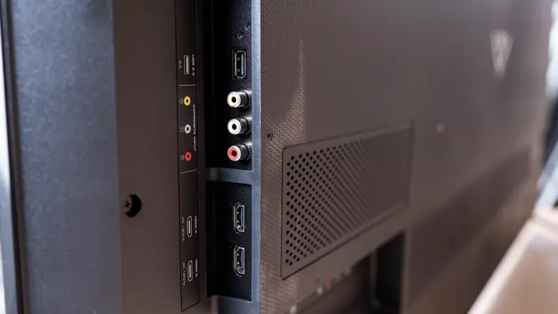 A close-up photo shows the various HDMI and A/V ports on the side of a Vizio TV.