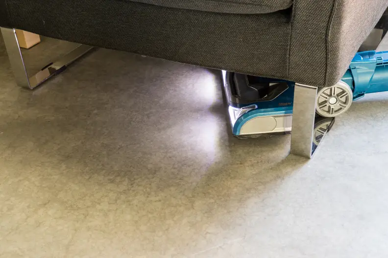 The brush head lights up so you can see dirt under furniture.