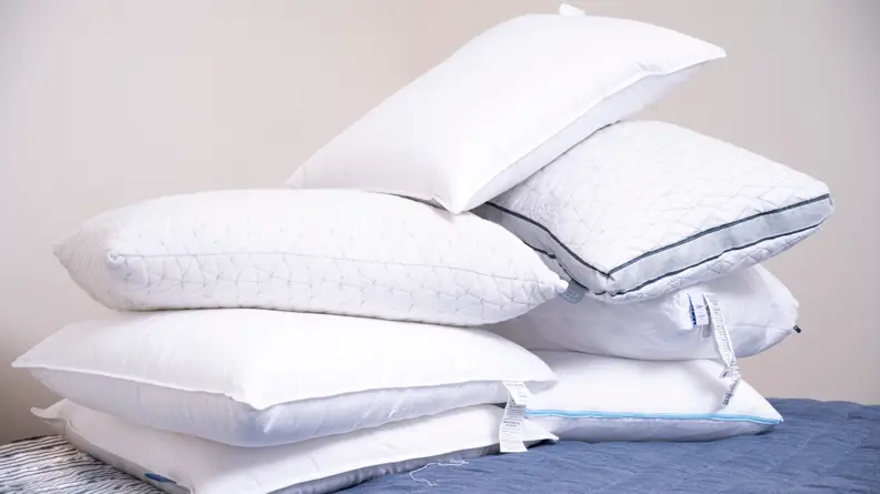 pile of several bed pillows
