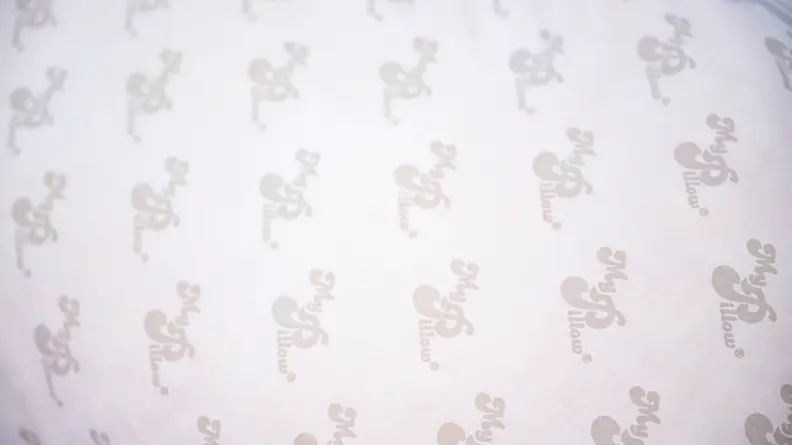 Pillow surface with the MyPillow logo printed all over.