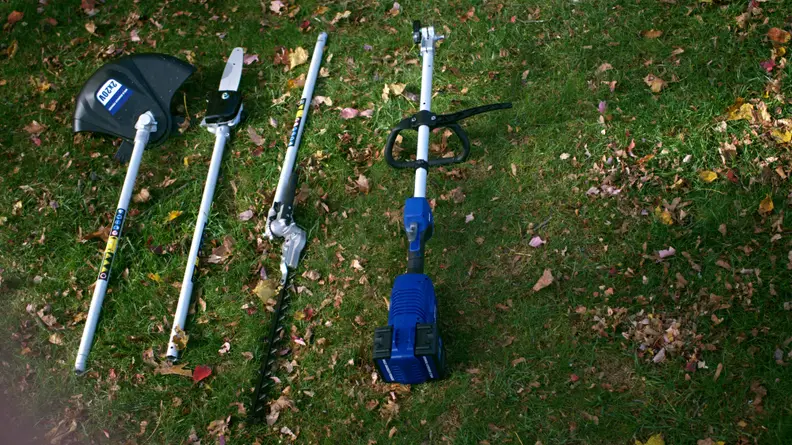 Four Wild Badger multitool attachments laying on the grass